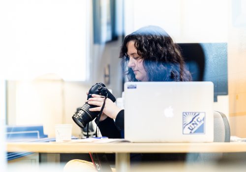 Student working at laptop with camera