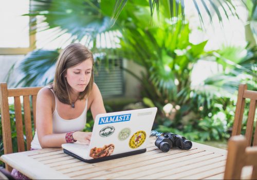 Student on a laptop in the glass house